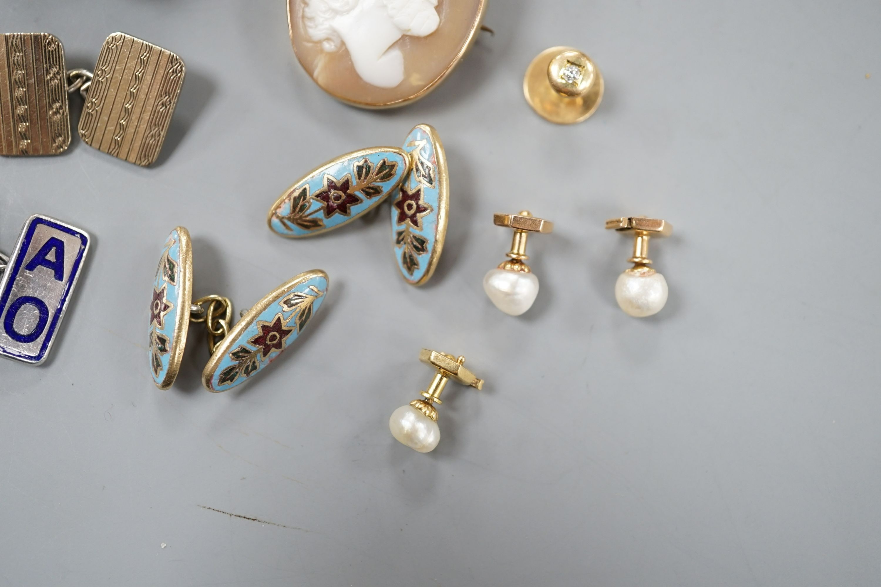 An early 20th century French white and yellow metal, green enamel(a.f.) set pomander, 19mm, on a white metal chain, three French (18ct poincon mark) and baroque pearl set dress studs, gross 3.5 grams, a diamond set 15ct